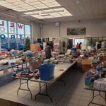 Nissan floor covered with tables of donations