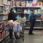 State troopers and a volunteer shopping for items