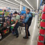 State trooper and a volunteer shopping for items