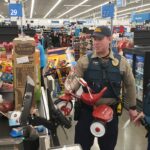 A trooper checking out with all of the items they are buying
