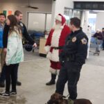 Santa talking to State Troopers