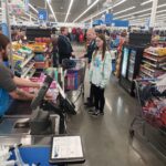 State troopers and a volunteer in the checkout lane at Walmart