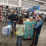State troopers and a volunteer shopping for squishmallows