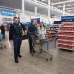 State troopers and a volunteer shopping