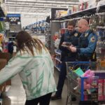 State troopers and a volunteer shopping for items