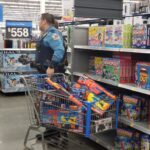 A state trooper with a basket full of nerf guns