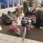 2 bikes next to bags of donations