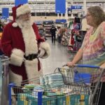 Santa talking to a volunteer