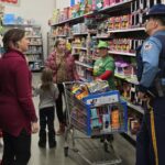 volunteers and state troopers in a toy isle