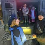 kids in a state troopers vehicle.