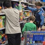 Volunteers shopping with a state trooper