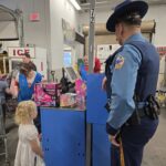 state trooper with a little girl