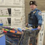 State trooper with a cart full of toys