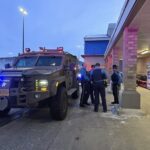 State troopers next to their vehicle