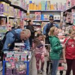 Volunteers shopping with a state troopers