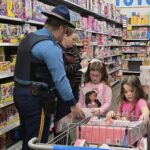 Young volunteers shopping with a state trooper