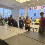 Volunteers next to a table