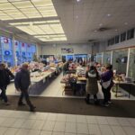 Volunteers next to tables that are filled with toys