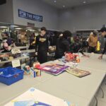 Volunteers next to tables