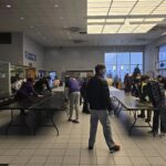 Volunteers next to empty tables