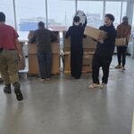 Volunteers carrying tables