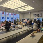 Volunteers next to tables