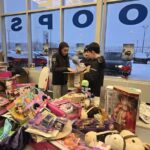 Unbacking a box next to a table filled with toys