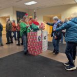 2 elves taking donations and putting them in big boxes