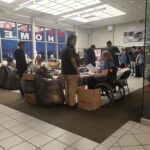 Volunteers around the instruction table