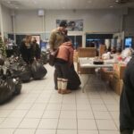 Volunteers grabbing large black bags